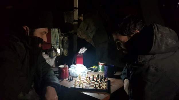 Servicemen trapped in the steelworks play chess
